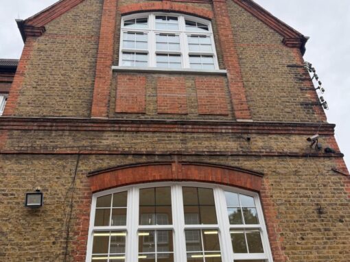 The gable end after the works, with new white windows to both floors