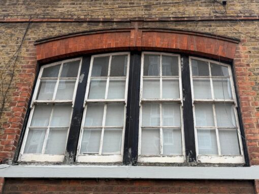 Wide arched window, close up of the decayed frames and sill